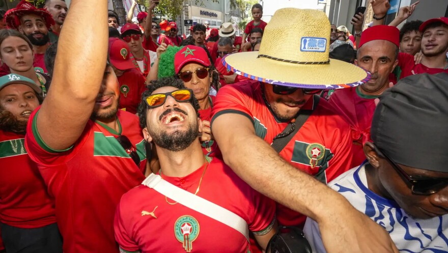 Morocco fan Ismail Karouitti dances with a group of fans before the FIFA World Cup Quarterfinal game between Morocco and France.