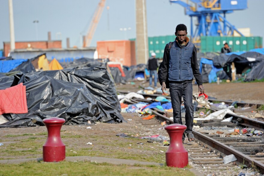 A man walks through a makeshift camp set up by migrants in Calais on May 17. There are an estimated 2,000 migrants in limbo in Calais.