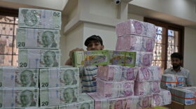 An employee sorts Turkish lira banknotes at a bank in the town of Sarmada in Syria's northwestern Idlib province. Authorities in northwest Syria are taking steps to substitute the plummeting Syrian pound with the Turkish lira to shield their opposition-held region from an economic crisis ahead of new US sanctions, an official said.
