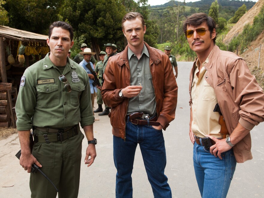 <em>Narcos</em> tells the story of the hunt for Pablo Escobar — a hunt in which DEA agents Steve Murphy (Boyd Holbrook, center) and Javier Peña (Pedro Pascal, right) worked closely with Colombian police. (Also pictured: Maurice Compte).