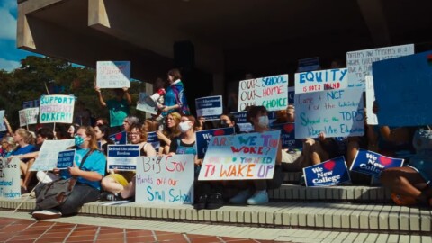 Students with signs protesting 