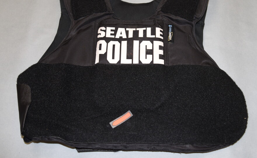 An arrow points to the place where a bullet hit a Seattle police officers bulletproof vest during a shootout with a robbery suspect.