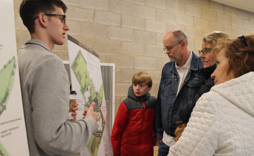 A representative from Massaro Construction shows off drawings of the next stages of the project.