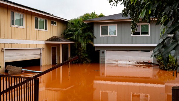 Floodwaters fill the ground level of homes in Waialua, Hawaii, Friday, March 20, 2026. (AP Photo/Mengshin Lin)