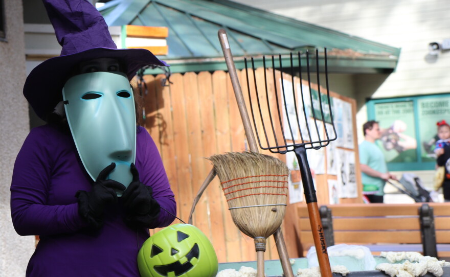 Marina Menendez hides behind her mask as she greets families at the last station at Boo at the Zoo on Wednesday, Oct. 28, 2026. She dressed up as Shock, one of the main villains from “The Nightmare Before Christmas.” (David Caine/WUFT News)