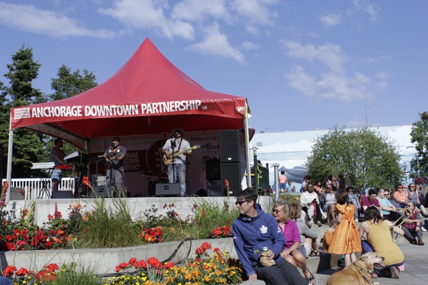 H3's Alex Cruver (left), Shaun Pacarro (center), George Noga (right), and Lee Thompson (behind) play for a crowd at Anchorage's Live After Five concert series on June 20.