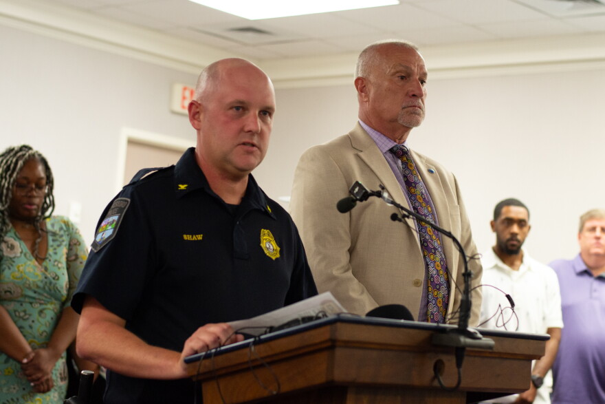 Police Chief David Shaw and Superintendent Jeffrey Cassell address reporters and community members during a press conference at the city council chambers.