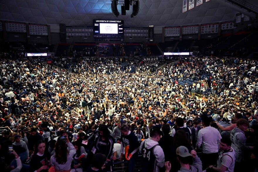 Fans storm the court at Gampel Pavilion after watching UConn win the NCAA Men's Basketball Tournament National Championship over San Diego State that was broadcast from Houston on April 3, 2023.