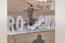 Jake Lang knocks over letters in an ice sculpture outside the Minnesota state Capitol on Feb. 5, 2026. The sculpture said Prosecute ICE. Lang turned it into Pro Ice.