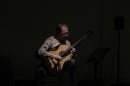 Guitarist Jamie Monck performing in a dark room