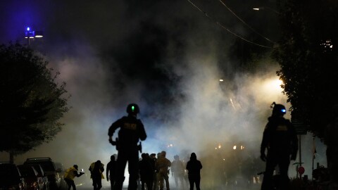 FILE - Law enforcement officers stand after deploying tear gas outside a U.S. Immigration and Customs Enforcement facility during a protest on Oct. 4, 2025, in Portland, Ore. (AP Photo/Jenny Kane, File)