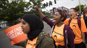 Students including senior Hafsa Yasin, left, and freshman Savannah Blackwell, center, chant on Friday, June 8, 2018, during a demonstration to call for an end to gun violence outside of Franklin High School in Seattle.