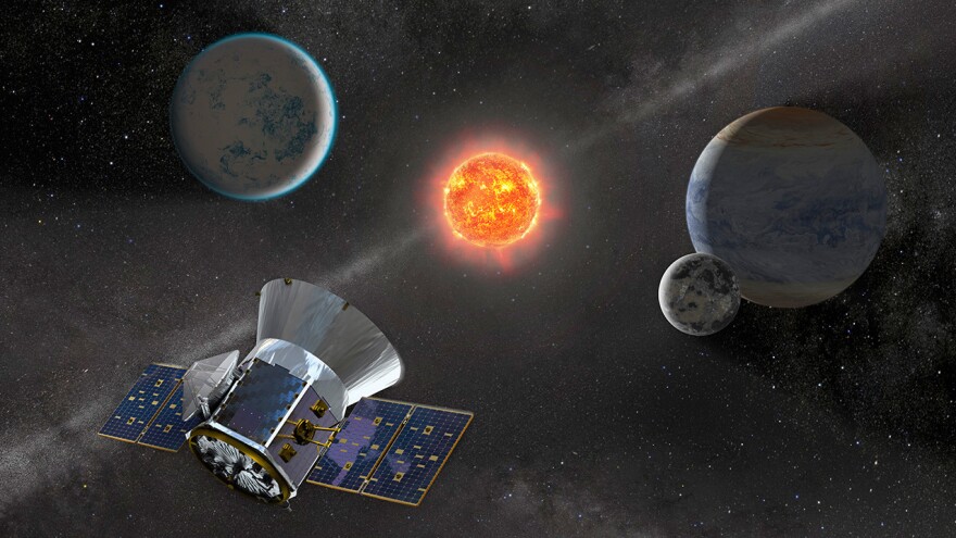 An artist's representation of NASA's Transiting Exoplanet Survey Satellite, or TESS, observing an M dwarf star with orbiting planets.