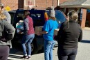 Volunteers load boxes of food into an SUV at a west Charlotte food share for federal workers and SNAP recepients