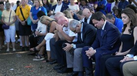 Florida Gov. Ron DeSantis, second from right, and his wife Casey, right, bow their heads during a prayer at a vigil for the victims of Saturday's mass shooting Sunday, Aug. 27, 2023, in Jacksonville, Fla.