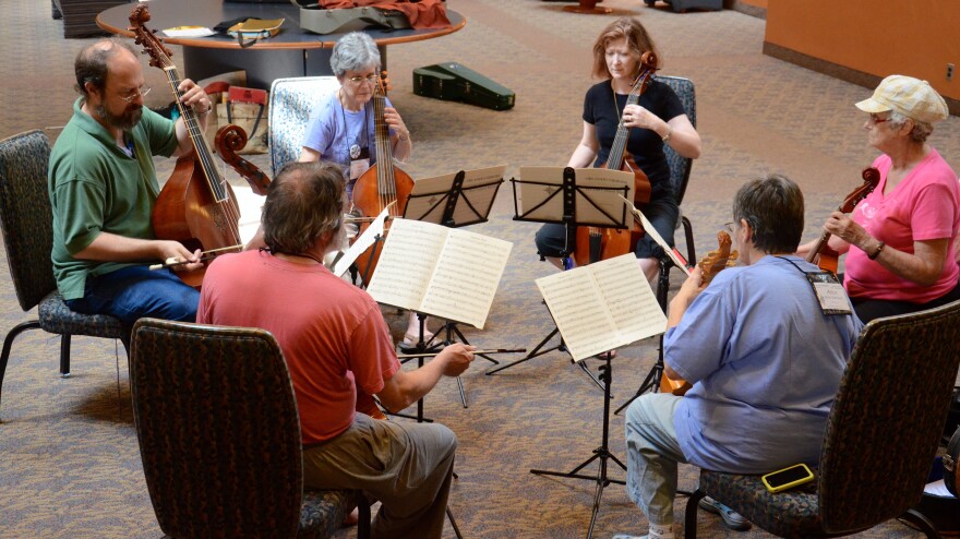 A consort of violas da gamba plays a fantasia by Orlando Gibbons in the common area of Clayton Hall at the University of Delaware to welcome participants during conclave registration.