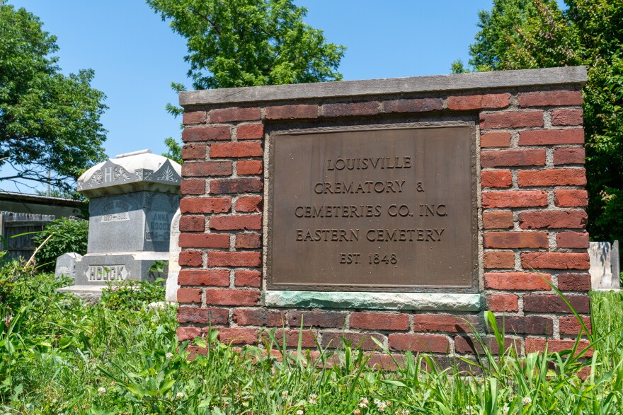 A brick marker with a metal sign marks Eastern Cemetery's location in Louisville. 