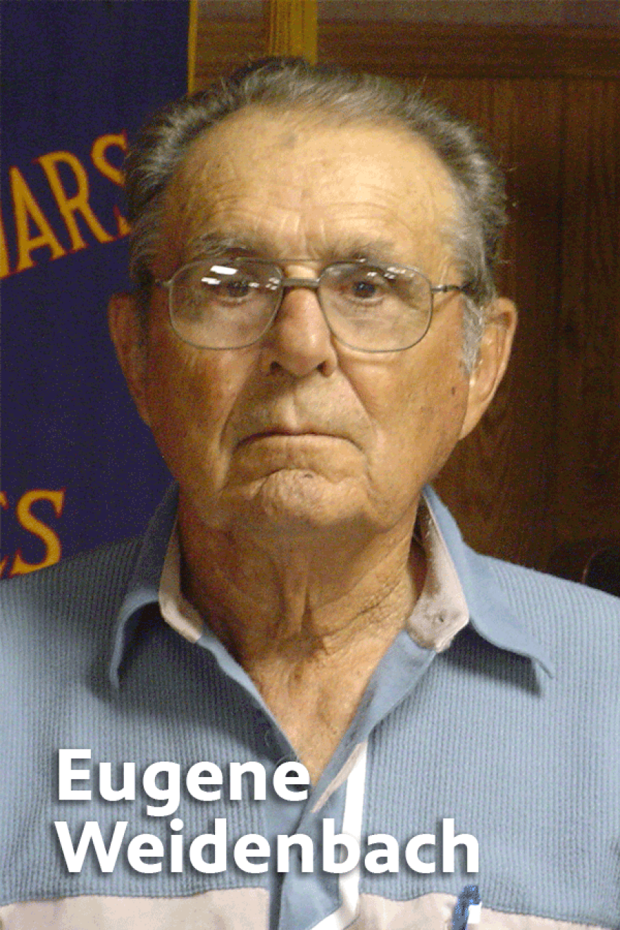 Elderly Eugene Weidenbach wearing glasses and a blue and white button up shirt