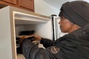 A chef from Miami Valley Meals places frozen meals into a Habitat for Humanity home freezer