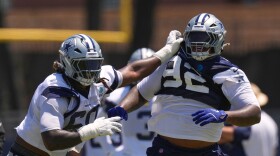 Dallas Cowboys offensive tackle Tyler Guyton, left, holds defensive tackle Quinnen Williams back during the NFL football team's training camp, Saturday, Aug. 1, 2026, in Oxnard, Calif.