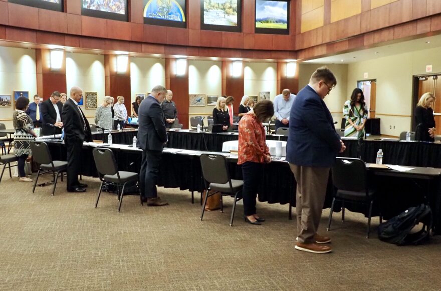 The Oklahoma Statewide Charter School Board members and staff pray at the beginning of a meeting Sept. 9, 2024, at the Oklahoma History Center in Oklahoma City. After supporting an unsuccessful attempt to open a Catholic charter school in the state, the board has received a letter of intent from a potential Jewish charter school.