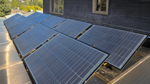 A set of plug-in solar panels are pictured on a rooftop. Portable solar panels come in a range of sizes and can be plugged into a wall outlet, something that legislators said makes them accessible to renters but requires additional safety considerations.