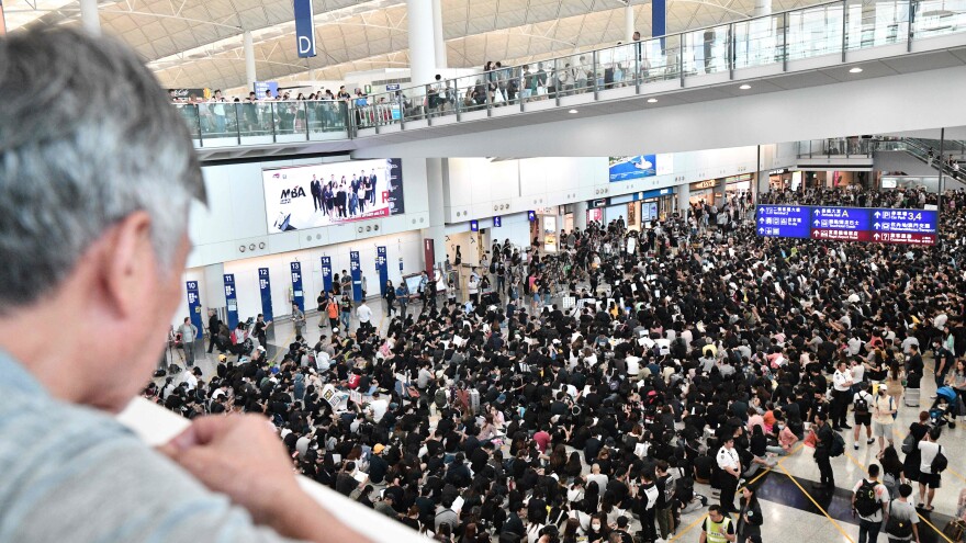 Hundreds of pro-democracy protesters rally at Hong Kong's international airport on Friday.