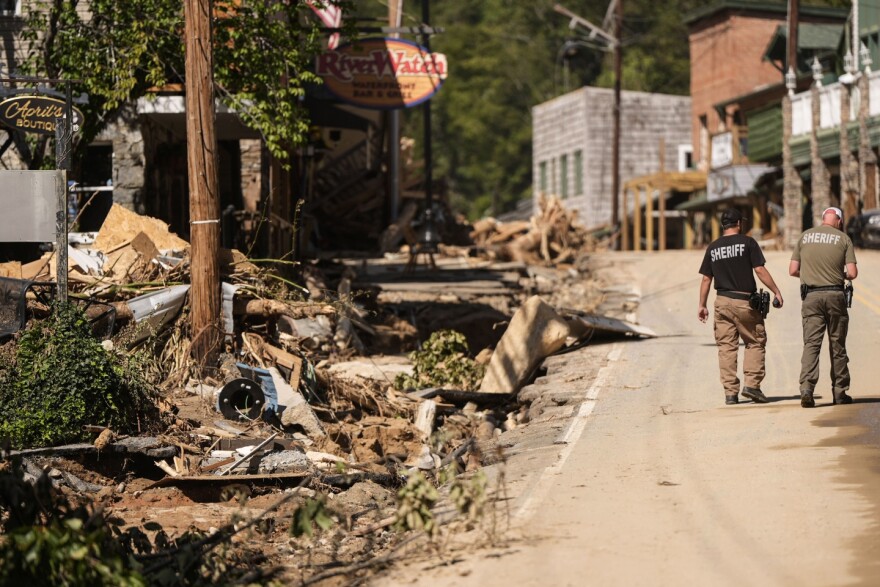 Two sheriff's deputies walk on the main street in the aftermath of Hurricane Helene, Wednesday, Oct. 2, 2024, in Chimney Rock Village, N.C. MIKE STEWART/AP