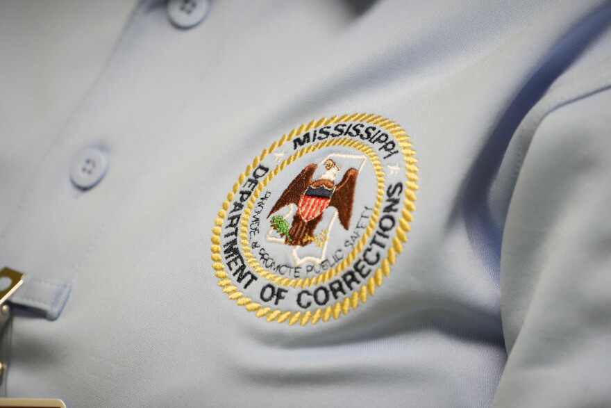 The logo of the Mississippi Department of Corrections is shown on the shirt of a corrections officer on Tuesday, May 9, 2023, at Central Mississippi Correctional Facility in Pearl, Miss.