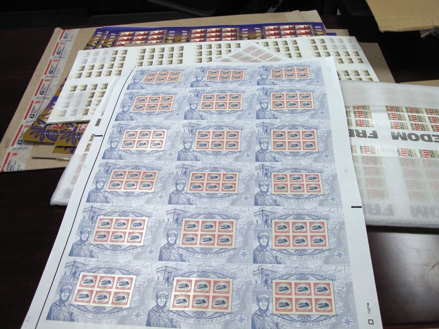 Postmaster General Patrick Donahoe owns every stamp printed since 1892. This box contains sheets of reprinted vintage stamps.