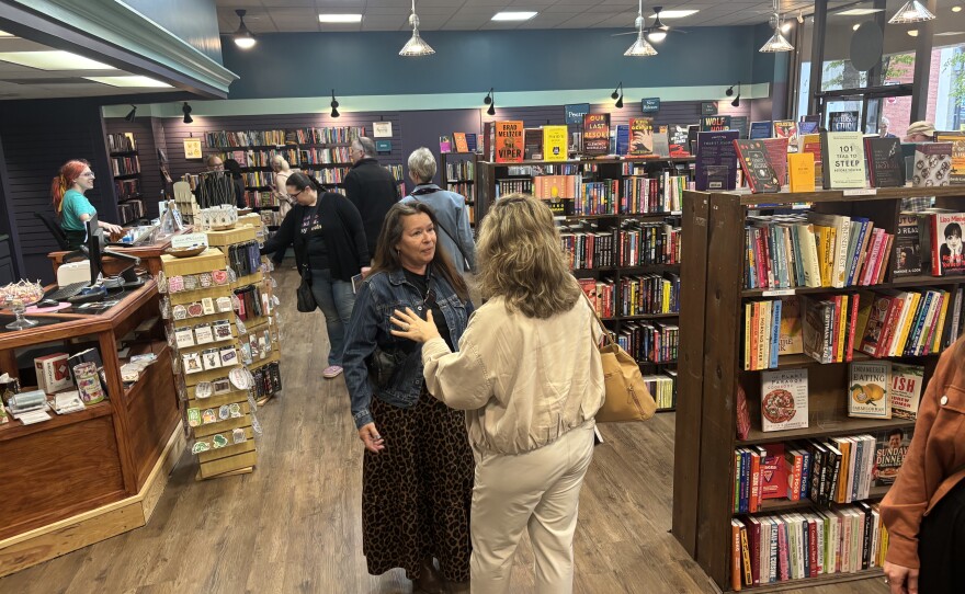 Guests wander the shelves of the Otto Bookstore's expansion.