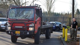 State Preparedness and Incident Response Equipment (SPIRE) Grant Program Coordinator Jim Jungling (right) inspects one of the new EarthCruiser all-terrain CORE Vehicles.