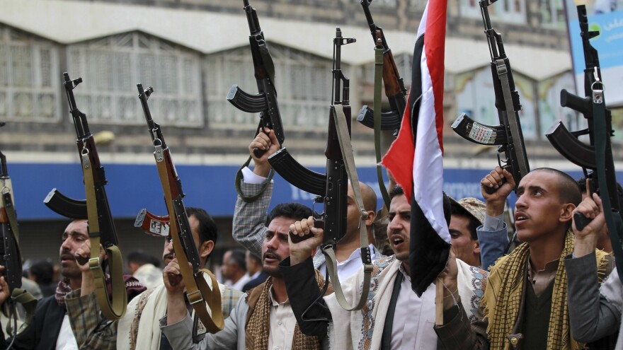 Shiite Houthi rebels hold up their weapons in a protest Thursday against Saudi Arabian airstrikes in Yemen's capital Sanaa. Saudi Arabia bombed military installations as the rebels, aligned with Iran, pressed ahead with their advance.