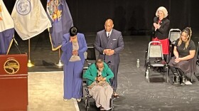 Mayor Sharon Owens cries as her mother delivers the closing prayer at the inauguration ceremony. Owens' husband stands with her, and their daughter is at right.