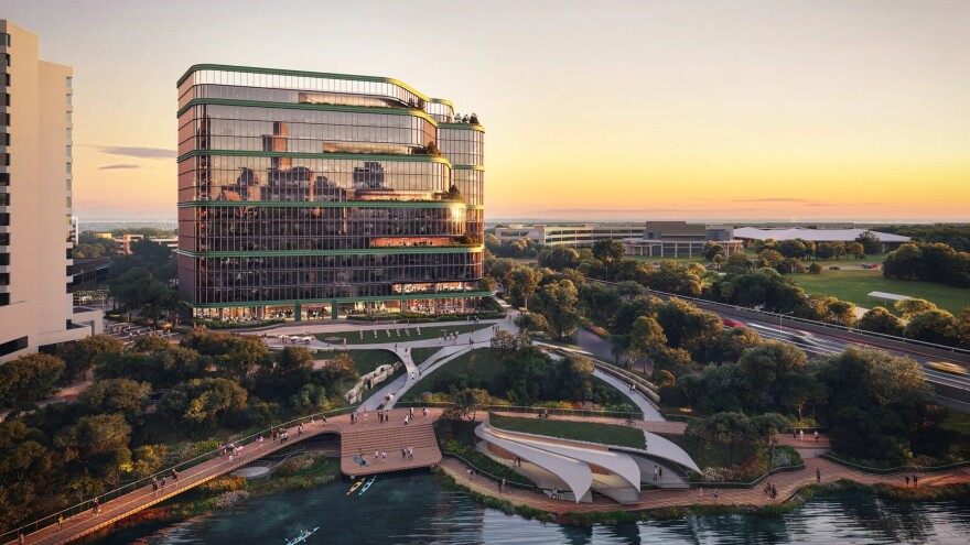A rendering of One Lady Bird Lake showing a boardwalk replacing the existing trail between South First Street and Congress Avenue. People are seeing walking along the boardwalk. Kayaks are pulling up to a small pier. A large shade structure fans out across part of the boardwalk. In the background, the windows of the One Lady Bird Lake building reflects the skyline of downtown Austin.