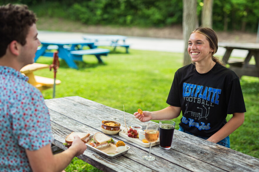 Two people eating at a picnic table