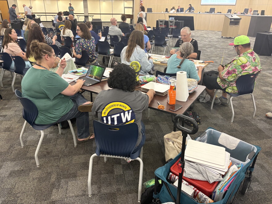 The Wichita teachers union conducted a sit-in demonstration at the Wichita Board of Education meeting on Monday, inviting teachers to bring work they usually do at home to complete during the meeting.