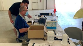 Men reviewing COVID tests 