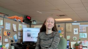 Zoey Knox sits at her desk in NHPR's newsroom