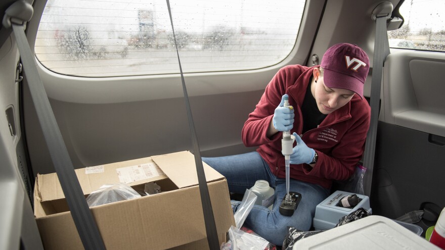 Maggie Carolan, part of Virginia Tech professor Marc Edwards' team, collects water samples and processes them in the back of their van in Flint.