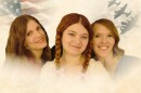 Three women in front of an American flag and war planes