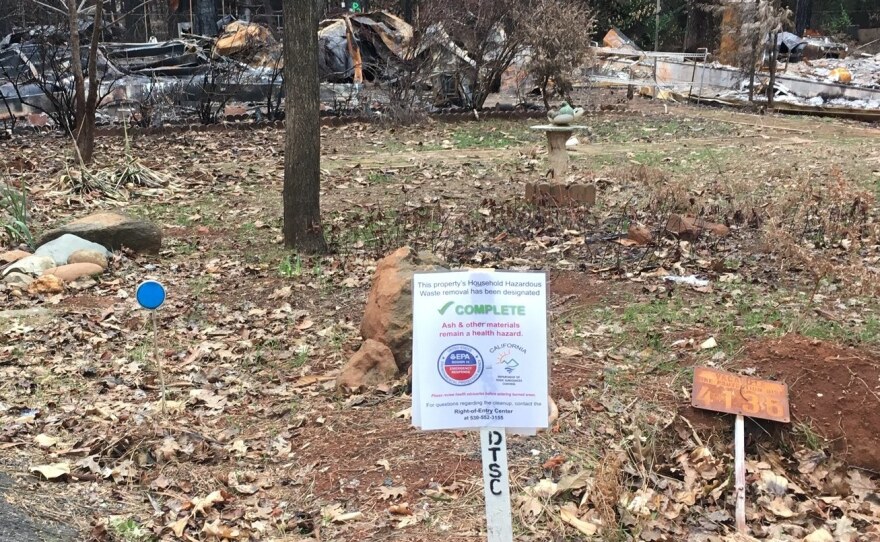 A sign marking a property in Paradise indicates that hazardous household items have been removed. But toxins in the ash and debris remain a concern.