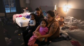 Evacuees Ally Shangin, her partner Garrett Kashatok and their four daughters – Katelynn, 9, Allyssa, 3, Lola, 2, and Shameka, 11 months – in their room at the Wingate hotel on Nov. 14, 2025.