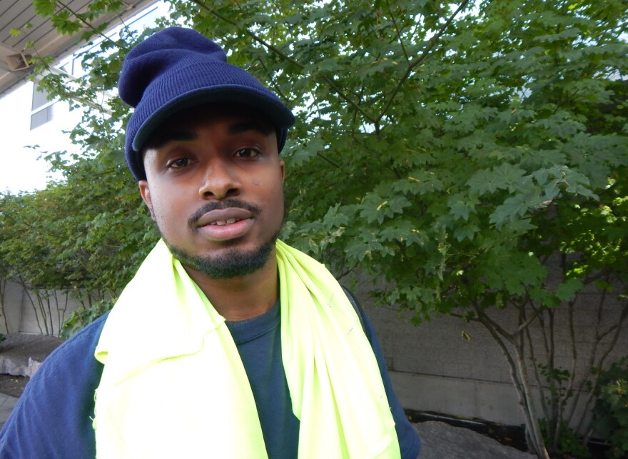 Liban Ahmed handles baggage at Seattle-Tacoma International Airport. He says he'll use the extra money to buy a car, save for college and visit his mom in Mogadishu, who he has not seen in 15 years.