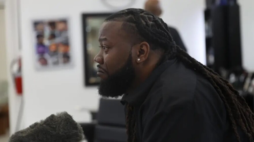 John "Speedy" Riddle sheds tears while being interviewed about Hurricane Katrina at A Shaving Grace barbershop in the southeast Houston area in July 2025.