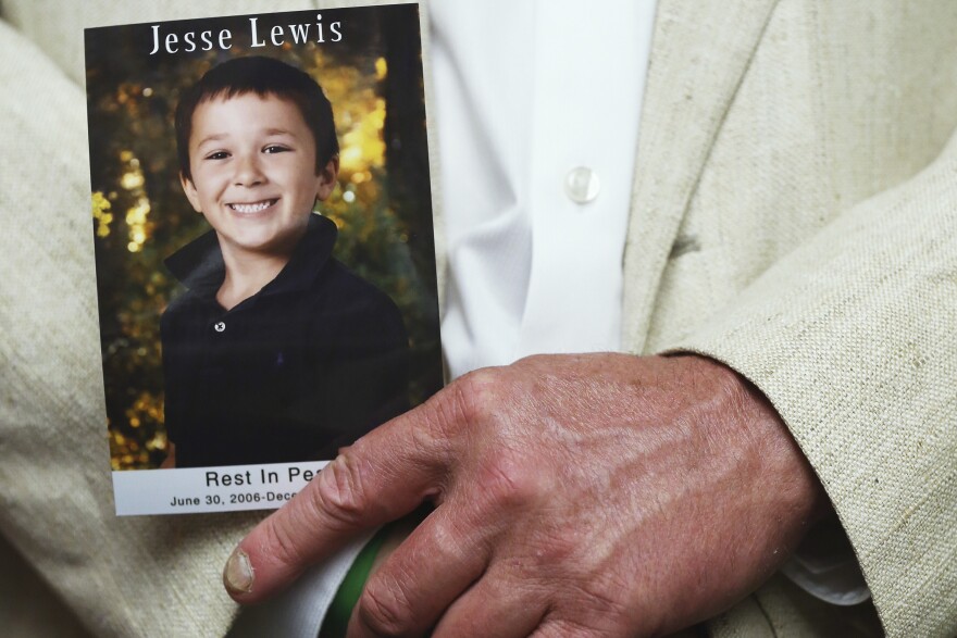 FILE: Neil Heslin holds a picture of his son Jessie Lewis, who was shot and killed during the shooting rampage at the Sandy Hook school in Newtown Conneticut., during a news conference on gun safety, on June 17, 2014 in Washington, DC. Family members of gun violence victims announced the "'Not One More' campaign urging Americans to call on Congress to pass better gun safety laws.