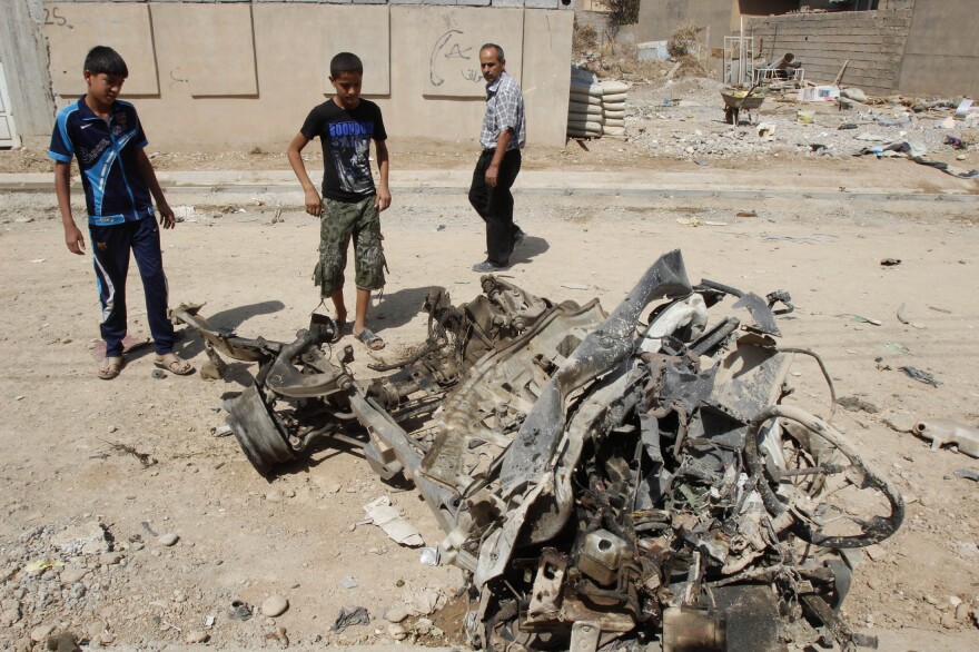 Civilians gather at the site of a bomb attack in Kirkuk last week.