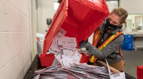 Election worker Sarah Sladek empties a box of submitted ballots at the Multnomah County Elections Office on November 2, 2020 in Portland, Oregon. (Nathan Howard/Getty Images)