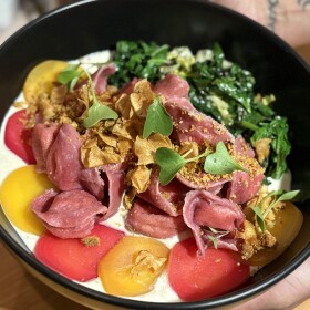 A colorful dish topped with greens  served at Side Yard Farm & Kitchen in Phoenix, Oregon.