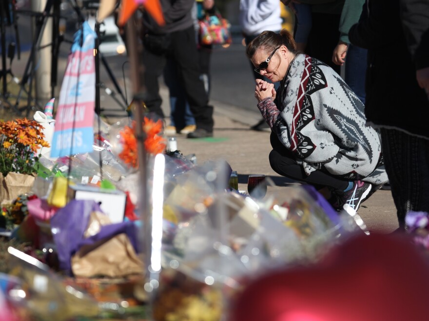 People visit a makeshift memorial near the Club Q nightclub on Monday in Colorado Springs, Colorado. On Saturday evening, a 22-year-old gunman entered the LGBTQ nightclub opened fire, killing five people and injuring others. [Scott Olson / Getty Images]